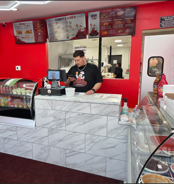 The Moe's Firehouse Kitchen counter with staff on a busy afternoon
