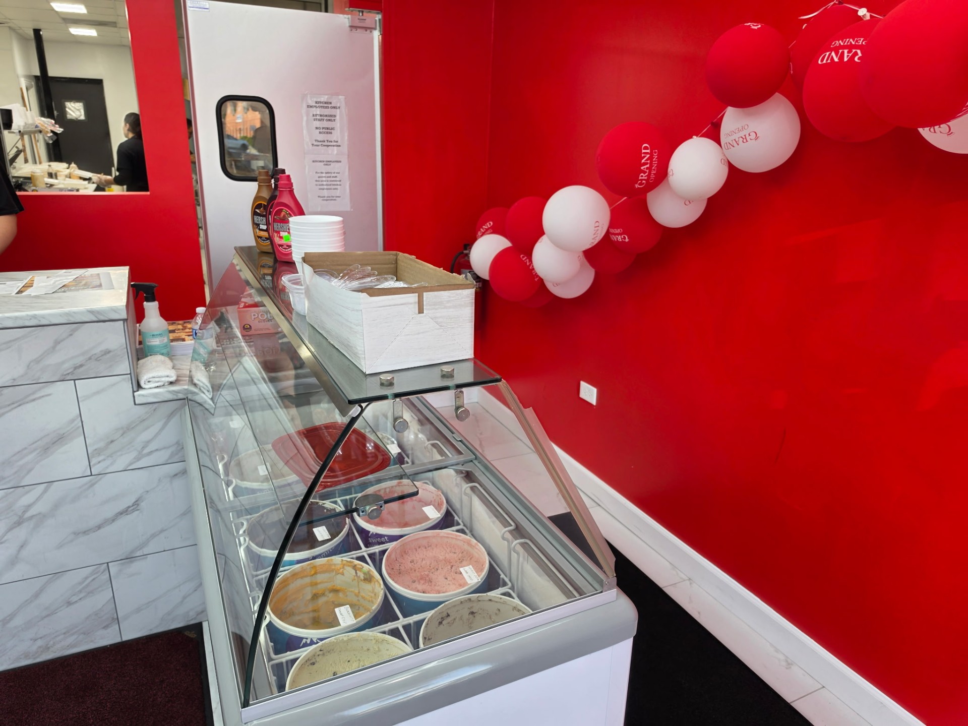Display case of ice cream tubs at Moe's Firehouse Kitchen
